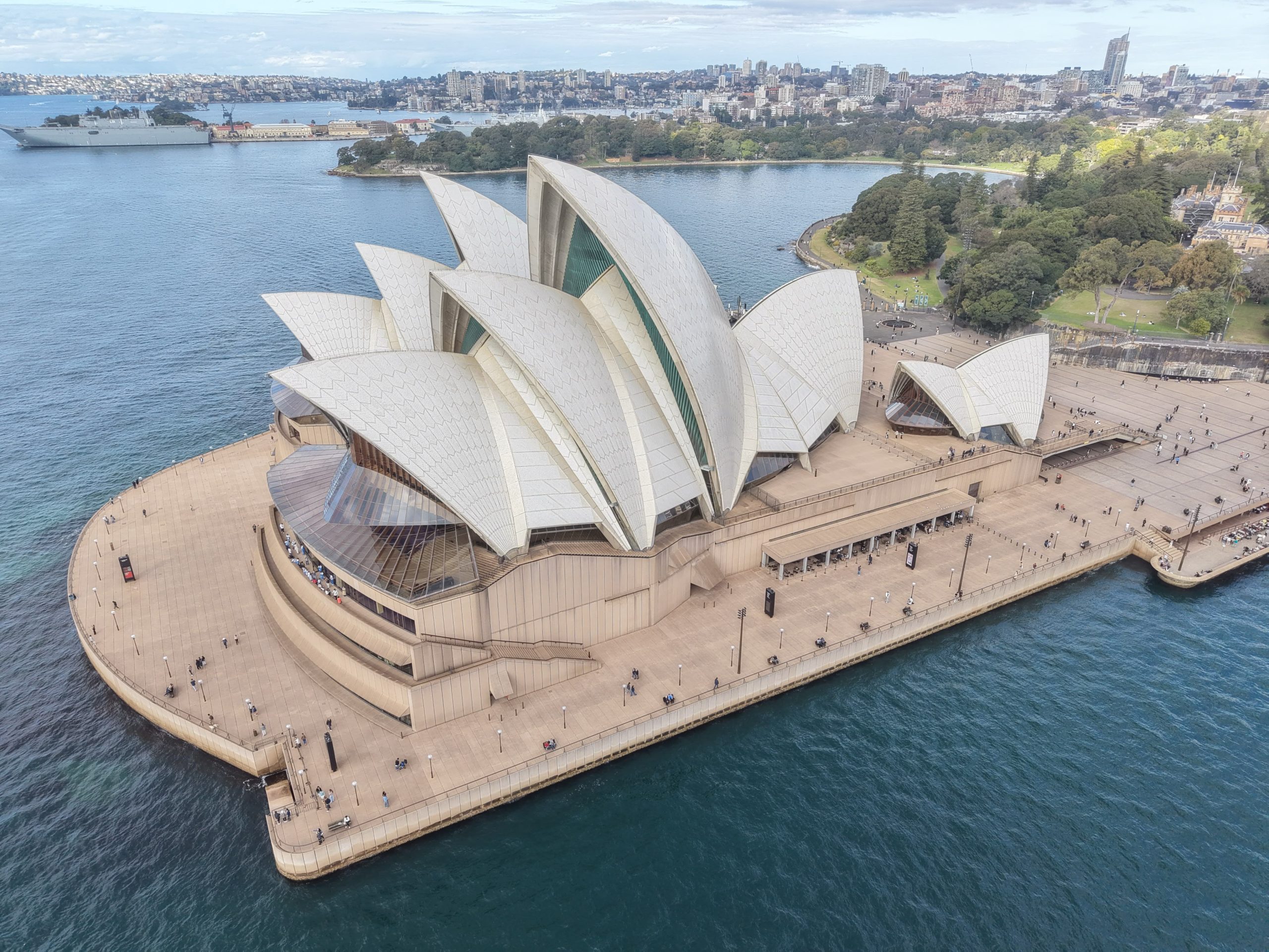 About Stunning aerial shot of the iconic Sydney Opera House surrounded by water and cityscape.